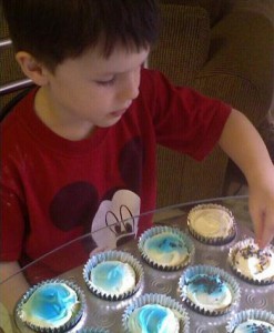 William decorates the cupcakes